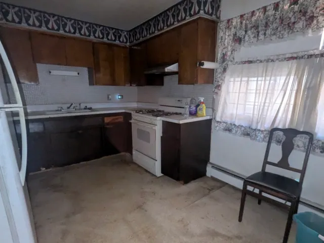 a kitchen with a stove and a refrigerator