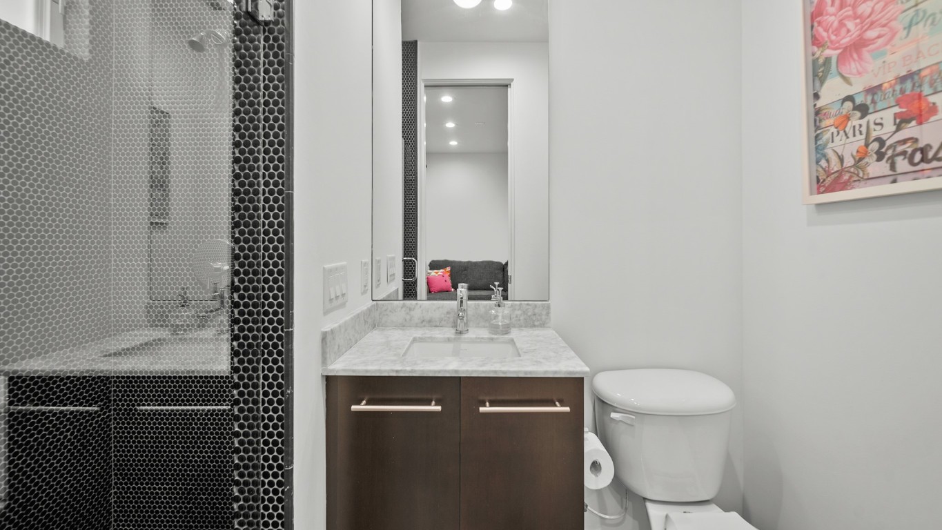 4302 Rose Street Houston, TX 77007 - Photo 22 of 25 a bathroom with a sink vanity mirror and toilet
