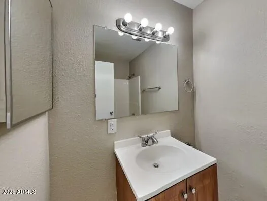 a bathroom with a sink vanity and mirror