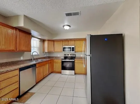 a large kitchen with cabinets and stainless steel appliances