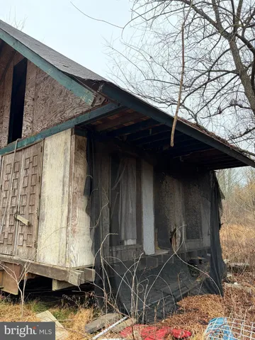 a room with exposed pipes and a window