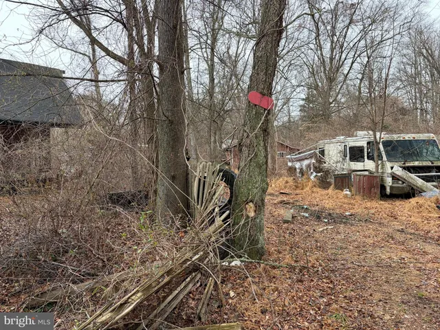 a view of a house with a large window and wooden fence