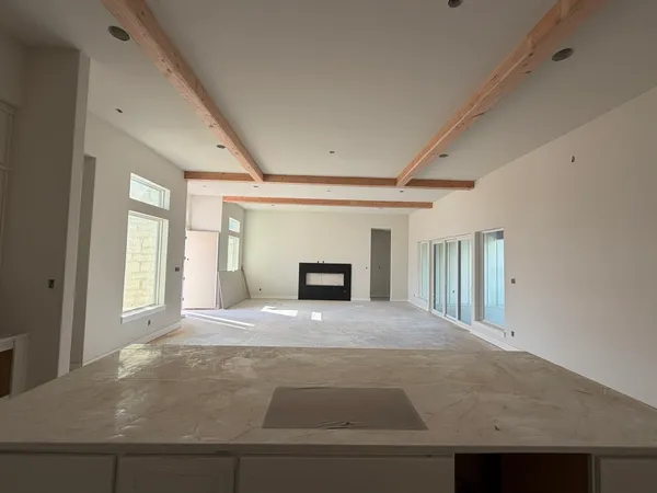 a large bedroom with a bed and a refrigerator