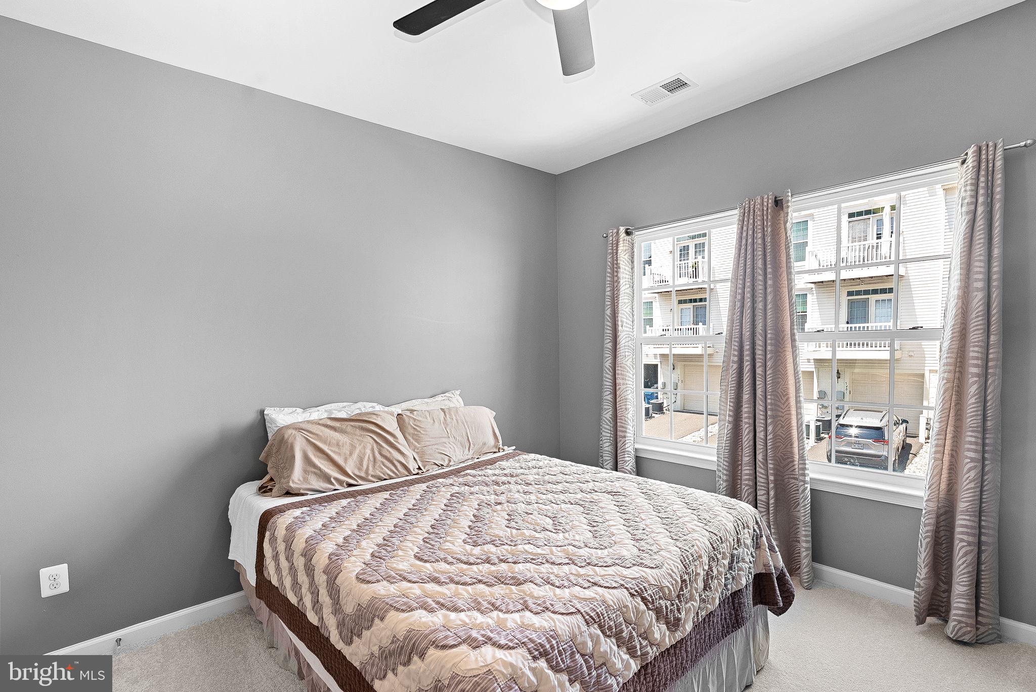 7471 Brunson Circle, Unit 10A Gainesville, VA 20155 - Photo 22 of 30 a bedroom with a bed and a window