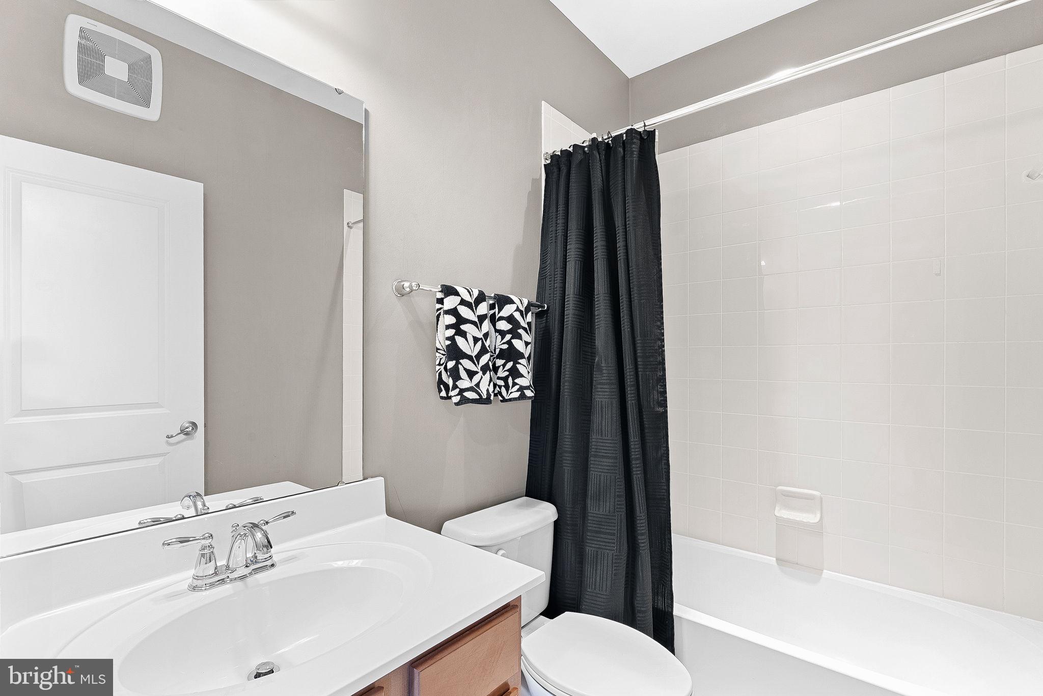 7471 Brunson Circle, Unit 10A Gainesville, VA 20155 - Photo 23 of 30 a bathroom with a sink toilet and shower