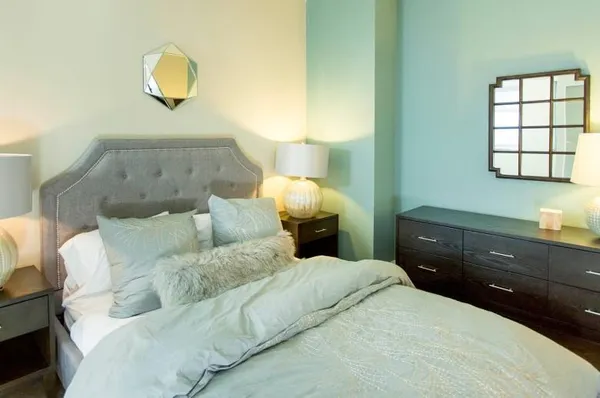 a bedroom with a bed and a lamp