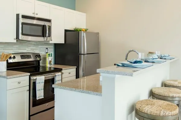 a kitchen with a sink a stove and refrigerator