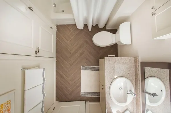 a bathroom with a toilet mirror and vanity