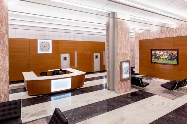 a living room with stainless steel appliances kitchen island granite countertop furniture and a rug