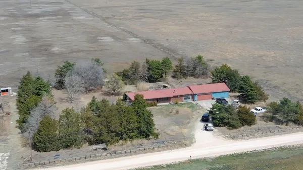 an aerial view of house with yard swimming pool and outdoor seating