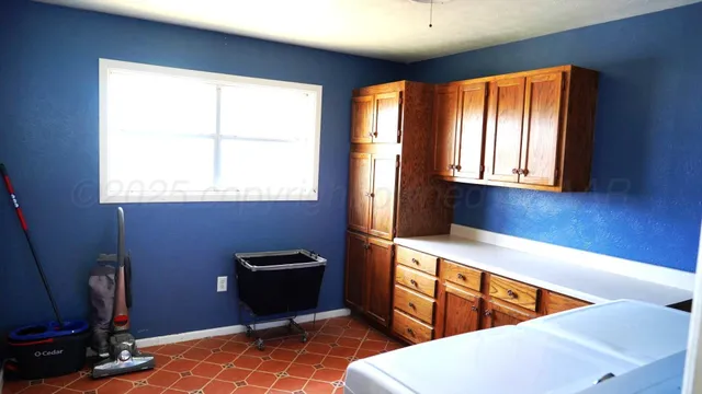a room with wooden floor and windows