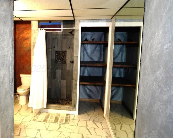 a view of walk in closet and bedroom view