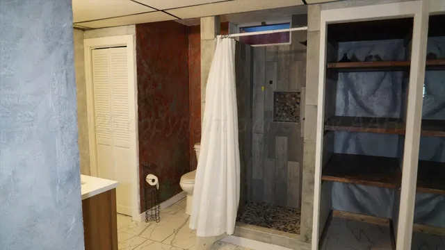 a bathroom with a glass shower door and a sink