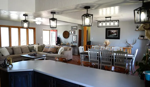 a living room with lots of furniture and chandelier