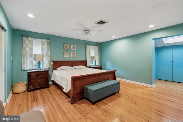 a spacious bedroom with a bed and a chandelier