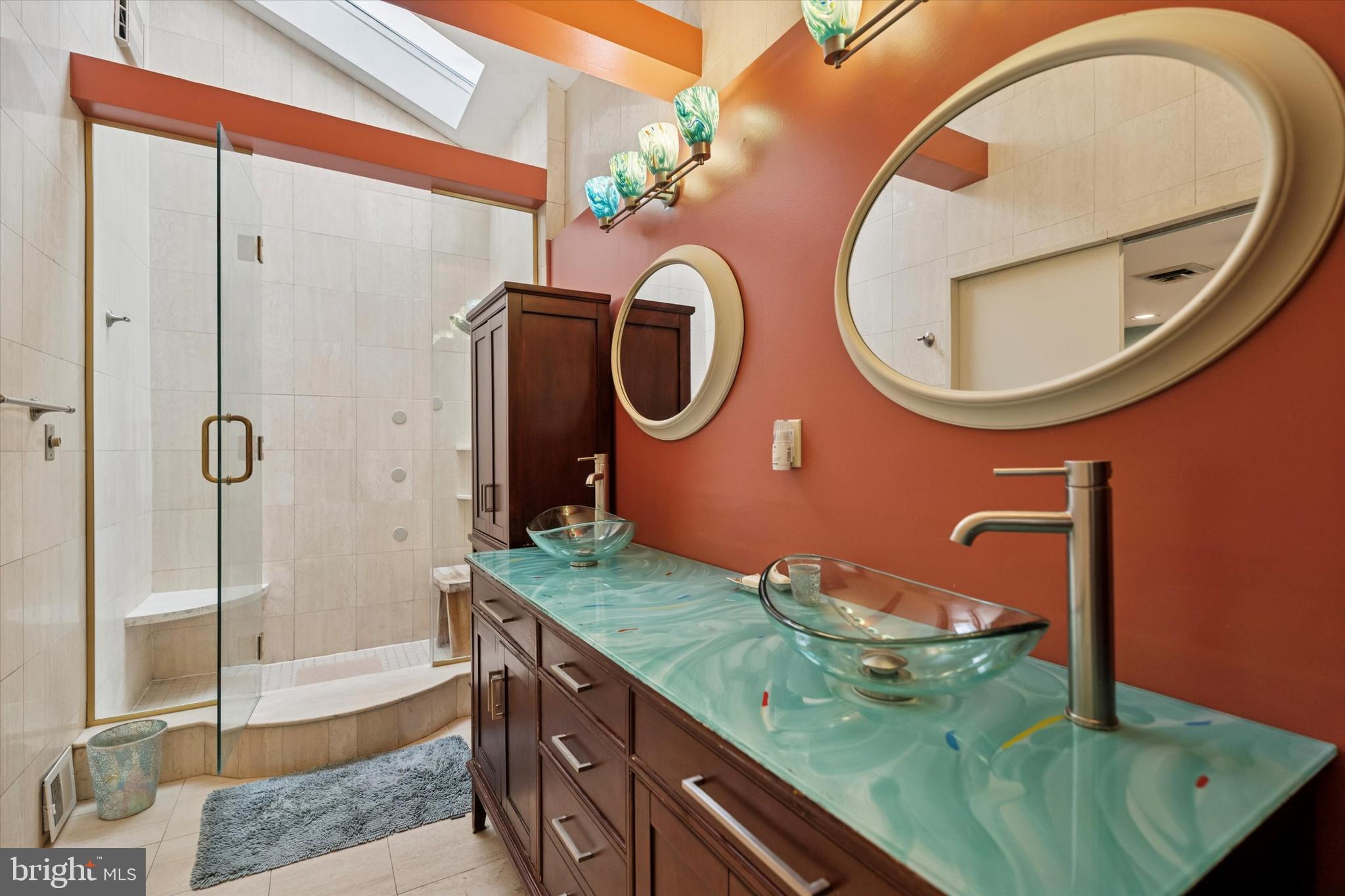 990 Indian Creek Road Jenkintown, PA 19046 - Photo 19 of 58 a bathroom with a sink a mirror and a shower