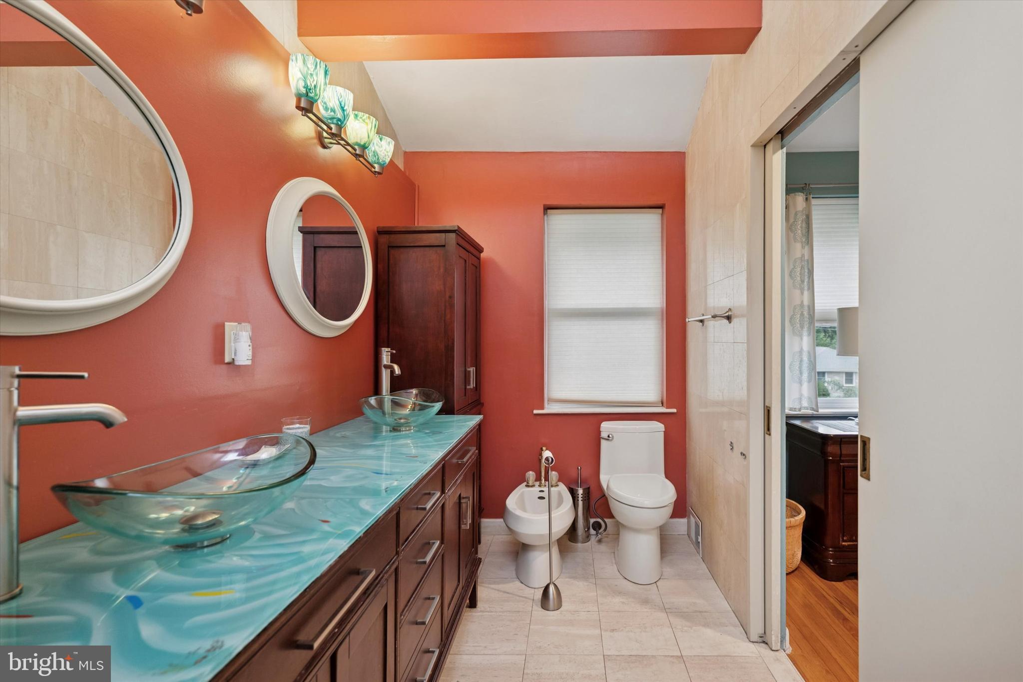 990 Indian Creek Road Jenkintown, PA 19046 - Photo 20 of 58 a bathroom with a granite countertop toilet sink and mirror