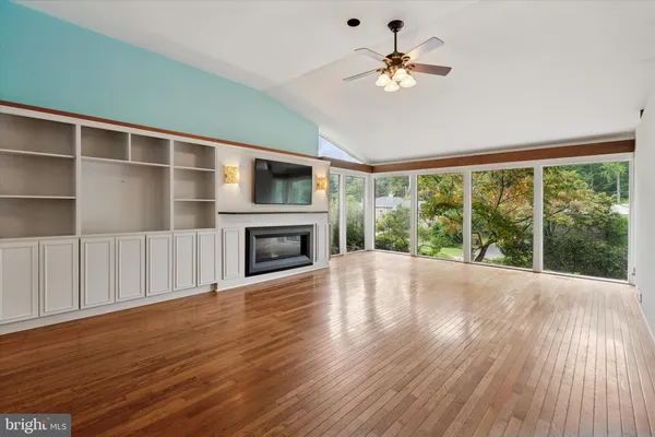 a view of an empty room with a fireplace and a window