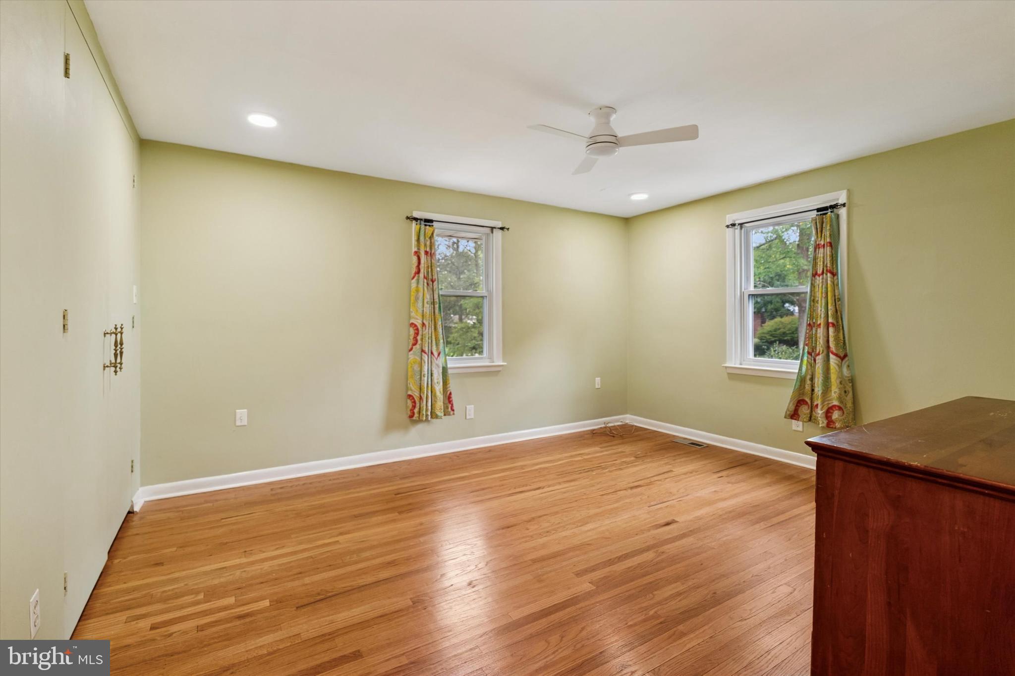 990 Indian Creek Road Jenkintown, PA 19046 - Photo 25 of 58 an empty room with wooden floor and windows
