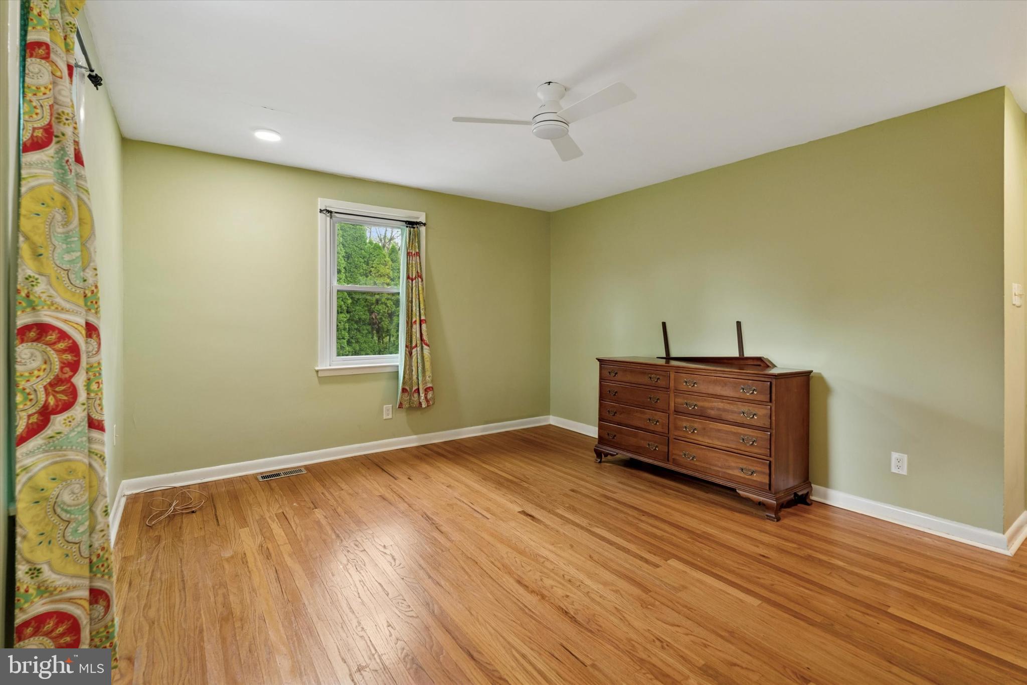 990 Indian Creek Road Jenkintown, PA 19046 - Photo 26 of 58 an empty room with wooden floor and windows
