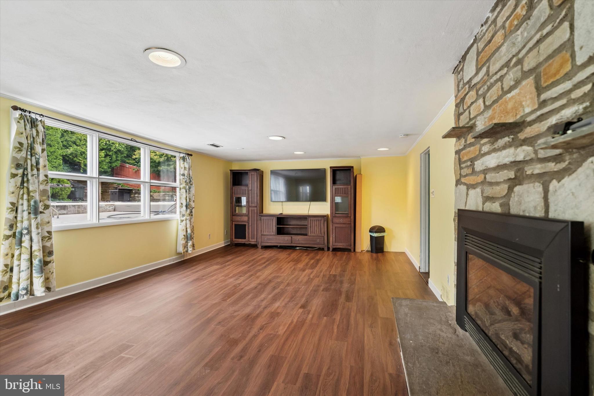 990 Indian Creek Road Jenkintown, PA 19046 - Photo 38 of 58 a view of empty room with wooden floor and fireplace