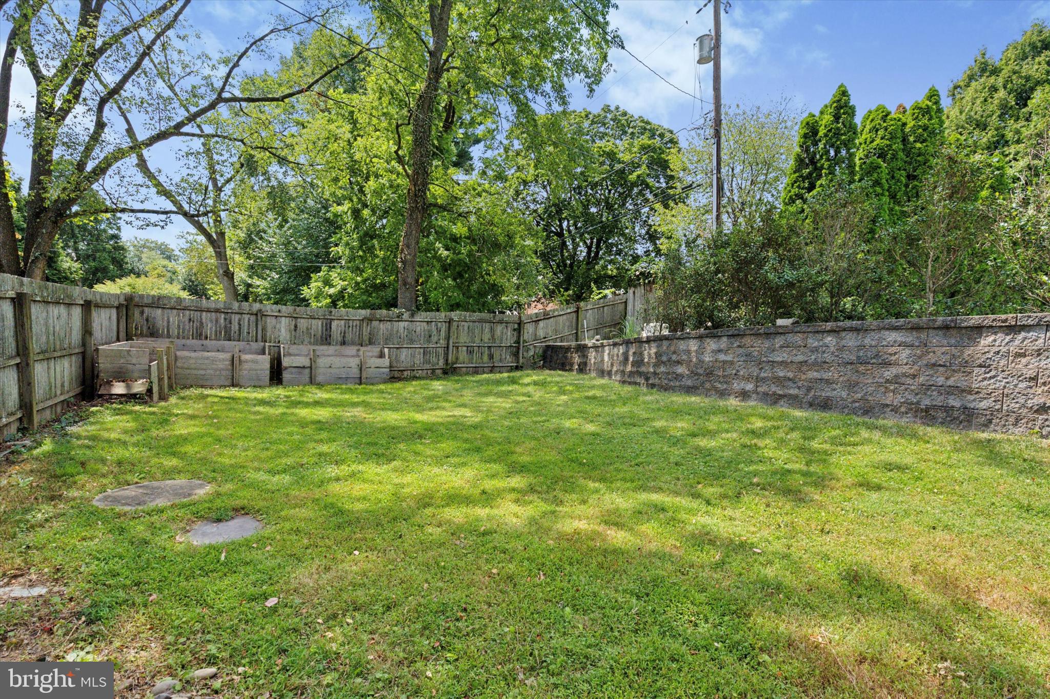 990 Indian Creek Road Jenkintown, PA 19046 - Photo 50 of 58 a view of a yard with a large tree and wooden fence