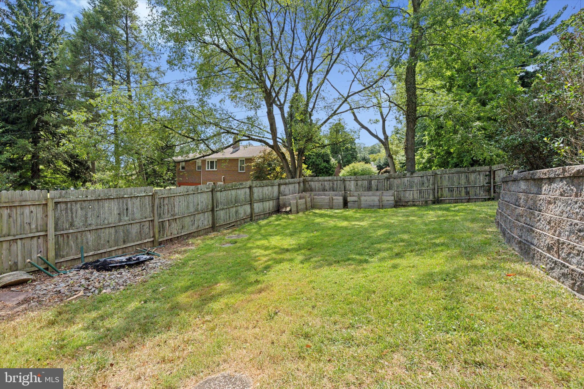 990 Indian Creek Road Jenkintown, PA 19046 - Photo 51 of 58 a view of a backyard with a large tree and wooden fence