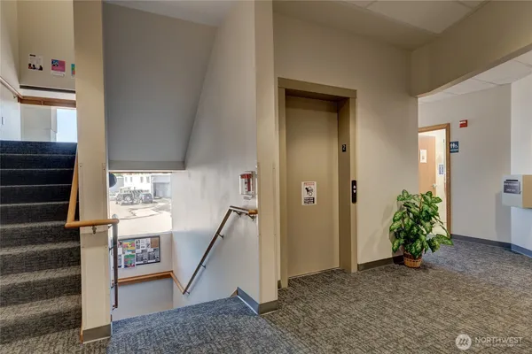 a view of an entryway with wooden floor and a livingroom