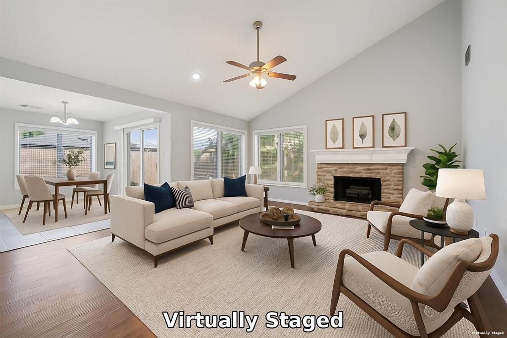a living room with furniture a fireplace and a chandelier
