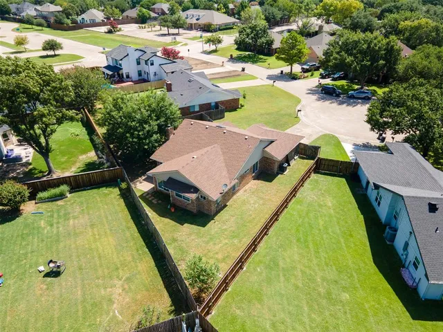 an aerial view of a house with swimming pool and lake view