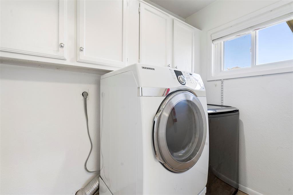 7 Chisos Court Trophy Club, TX 76262 - Photo 12 of 14 Laundry room with cabinet space and washer and dryer