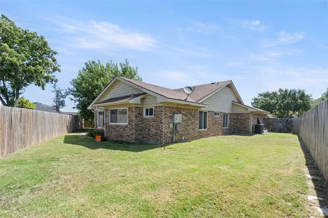 a front view of a house with yard and green space