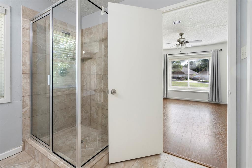 7 Chisos Court Trophy Club, TX 76262 - Photo 6 of 14 Primary Full bathroom with stand up shower, a ceiling fan, and tile patterned flooring