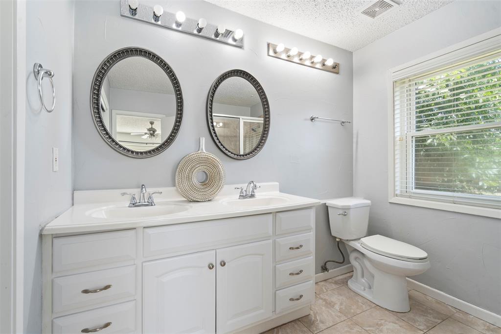 7 Chisos Court Trophy Club, TX 76262 - Photo 7 of 14 Primary Full bathroom featuring double vanity, a ceiling fan, tile patterned flooring, and a shower
