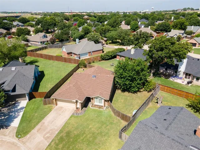 an aerial view of a house with a swimming pool