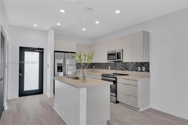 a kitchen with stainless steel appliances granite countertop a sink and stove top oven