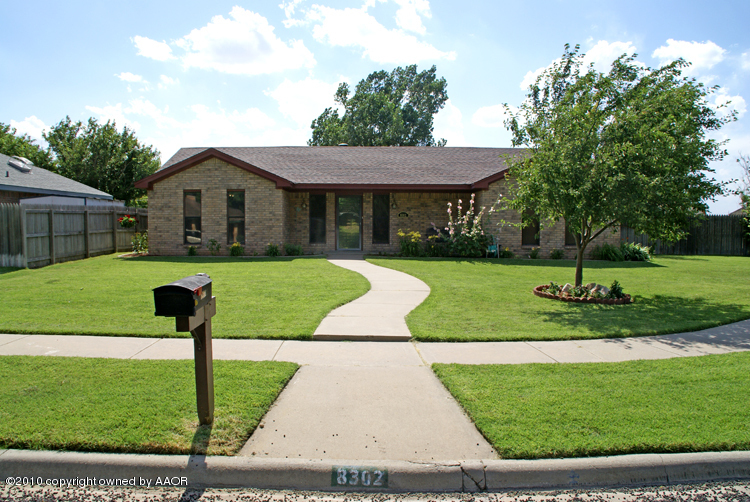 8302 Ranier Drive Amarillo, TX 79110 - Photo 1 of 32 a front view of a house with garden