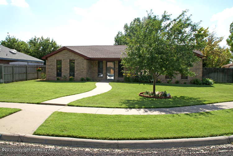 8302 Ranier Drive Amarillo, TX 79110 - Photo 2 of 32 a view of a house with a yard