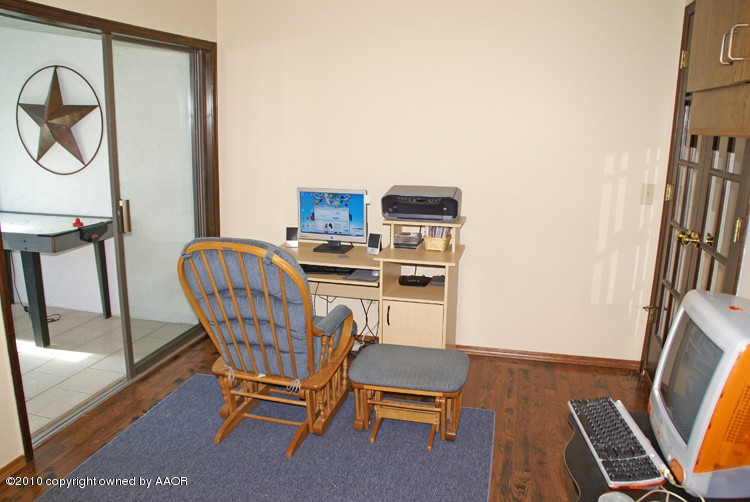 8302 Ranier Drive Amarillo, TX 79110 - Photo 12 of 32 a view of a workspace with furniture and a window