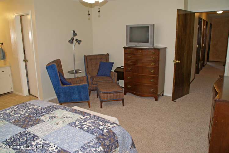 8302 Ranier Drive Amarillo, TX 79110 - Photo 16 of 32 a bedroom with a bed and furniture