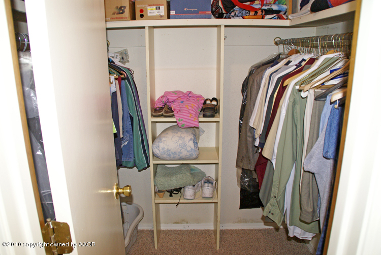 8302 Ranier Drive Amarillo, TX 79110 - Photo 18 of 32 a view of walk in closet with clothes and shoes