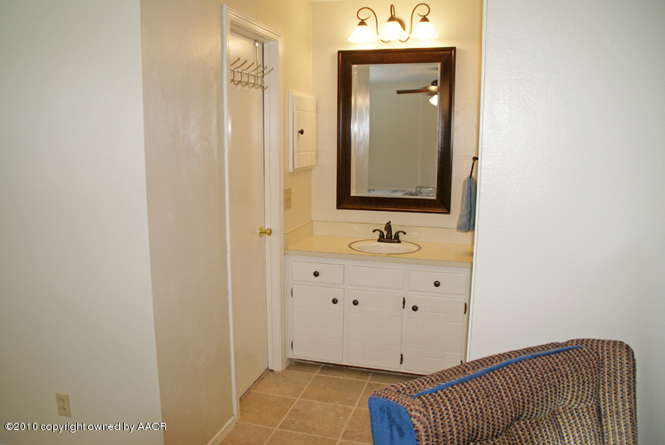 8302 Ranier Drive Amarillo, TX 79110 - Photo 19 of 32 a bathroom with a sink mirror and vanity