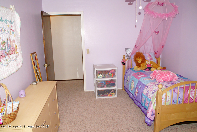 8302 Ranier Drive Amarillo, TX 79110 - Photo 25 of 32 a bedroom with a bed a couch and dresser