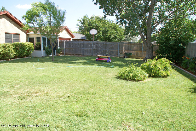 8302 Ranier Drive Amarillo, TX 79110 - Photo 30 of 32 a backyard of a house with plants and tree