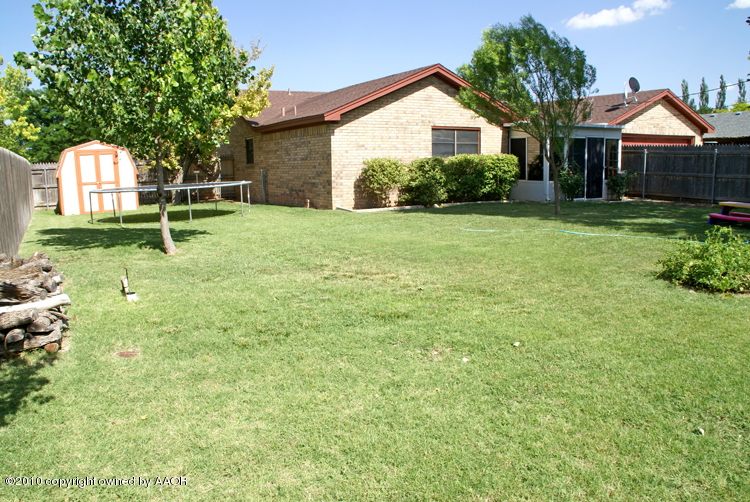 8302 Ranier Drive Amarillo, TX 79110 - Photo 31 of 32 a front view of a house with a yard and garage