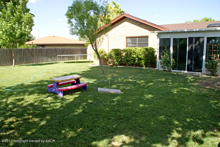 8302 Ranier Drive Amarillo, TX 79110 - Photo 32 of 32 a backyard of a house with table and chairs