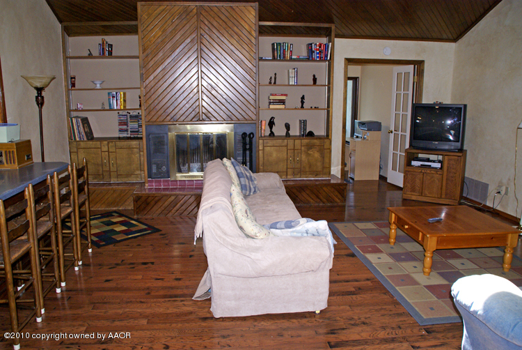 8302 Ranier Drive Amarillo, TX 79110 - Photo 6 of 32 a view of a livingroom with furniture flat screen tv and couches