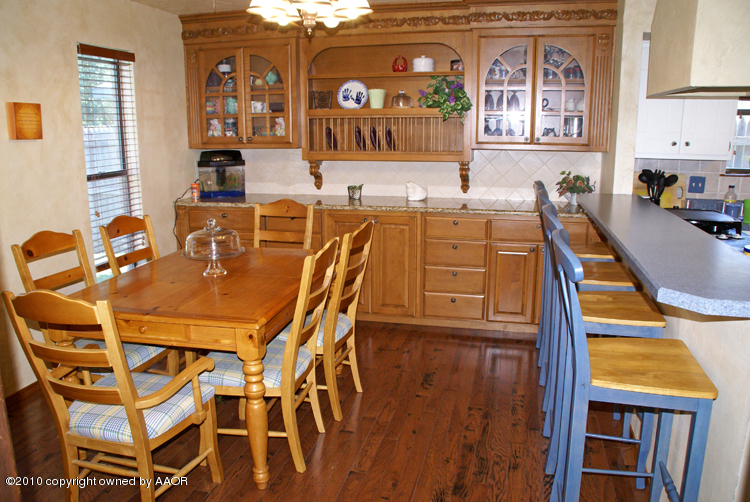 8302 Ranier Drive Amarillo, TX 79110 - Photo 7 of 32 a dining room with furniture and wooden floor