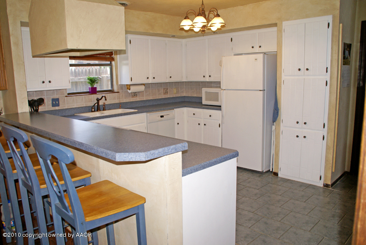 8302 Ranier Drive Amarillo, TX 79110 - Photo 9 of 32 a kitchen with stainless steel appliances a sink a refrigerator and a stove