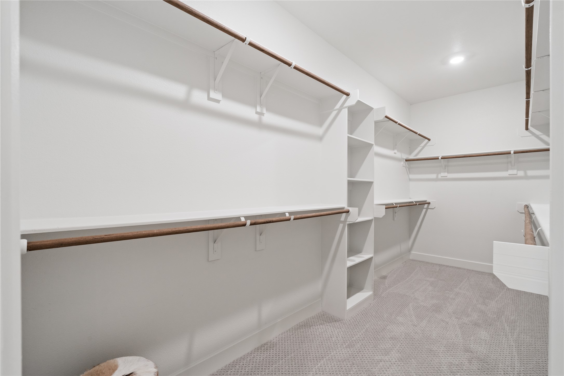 6451 Rena Street Houston, TX 77092 - Photo 25 of 33 Expansive walk in closet with multiple hanging sections and built in shelving for structured organization.
